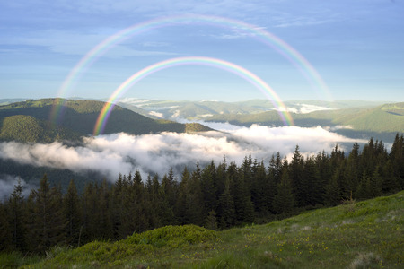 Panorama of the misty mountains from the peak of Synyak in the Gorgan Mountains above Bukovel resort. The sea of fog in the valley against the background of high peaks in a fairy-tale radianceの写真素材