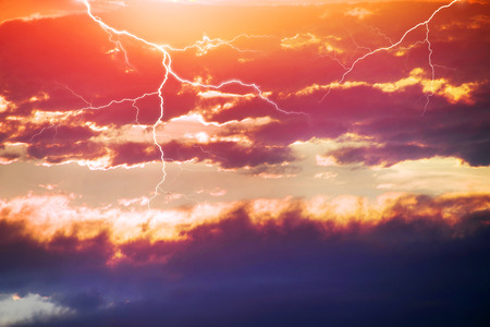 Beautiful clouds scenic natural phenomena in a cloud of colorful picturesque shades and dazzling colors - clouds after rain and bad weather in the storm with lightning over the mountainsの写真素材