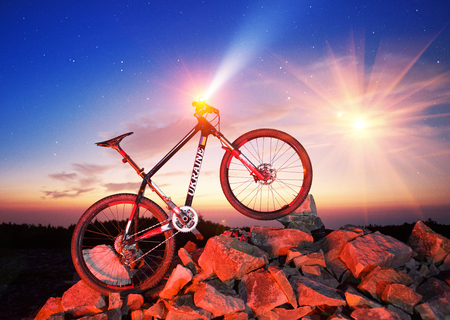 Starry night in the wild Carpathians mountain bike racer  background on the background of night lights.  peak of Sinyak is an extreme journey for a bicycle,  off-road character  dangerous pathの写真素材
