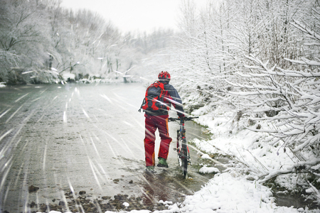 Snowy whirlwinds in a bike ride with a Christmas holiday in the wild Ukrainian river. Hurricane winter wind carries snow whirlwinds on fast ice riders of Ukraine, to the Carpathians.の写真素材