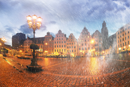The center of the beautiful old city of Wroclaw with festive illuminations after sunset. Unique europe Christian and residential architecture attracts many tourists touristsの写真素材