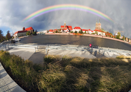 Polish famous archecture against the background of the panorama of the Odra river in the beautiful morning light of the famous temples of Gothic art with a picturesque colorful autumn colorの写真素材