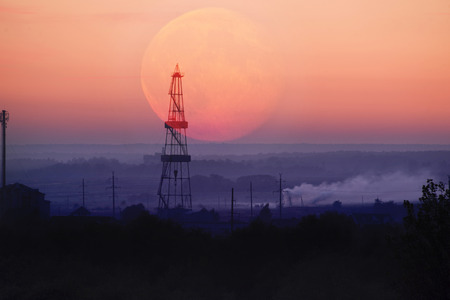 oil rig at night on the moonrise in Ivano-Frankivsk on the outskirts of the city explored the reserves of a valuable deposit of Ukrainian oil and gas for the country's energy independenceの写真素材