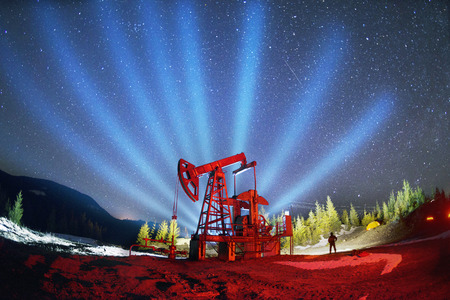  Ukrainian Carpathians, the classical technology of oil and gas extraction by electric pumps against the background of the eternal beauty of the stars of the universe of the Galaxyの写真素材