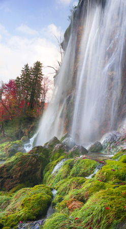 Plitvice Waterfalls in Croatia is one of the famous famous places in Europe, very beautiful. The jets of water on the background of autumn forests at sunrise are very picturesqueの写真素材