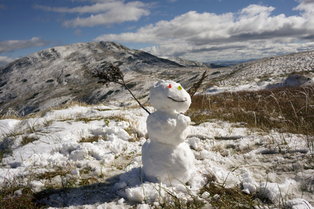Snowman, Snow Woman on the top of Goverla in September, the first snow and cold on the highest peak of the Carpathians, Ukraine. Traditions of the holiday and wild nature in harmonyの写真素材