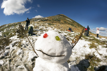 Snowman, Snow Woman on the top of Goverla in September, the first snow and cold on the highest peak of the Carpathians, Ukraine. Traditions of the holiday and wild nature in harmonyの写真素材