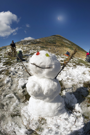 Snowman, Snow Woman on the top of Goverla in September, the first snow and cold on the highest peak of the Carpathians, Ukraine. Traditions of the holiday and wild nature in harmonyの写真素材