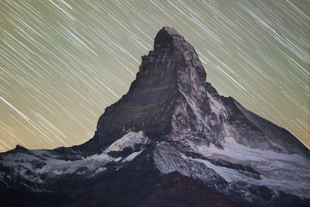 The fall slopes of the resort of Zarmatt are a local landmark and a bright beautiful landscape with the famous Matterhorn peak in autumn in Switzerland.の写真素材