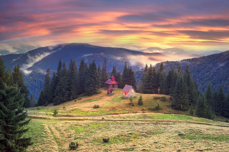 Trekking in the fall in a severe cold to a high-altitude wooden church on the roving of Rogneska Christian in the misty September. Coniferous and deciduous forests in fogs panoramaの写真素材