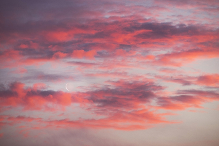 Sunset and sunrise with beautiful red clouds and at the same time the east of the Young Moon is a...