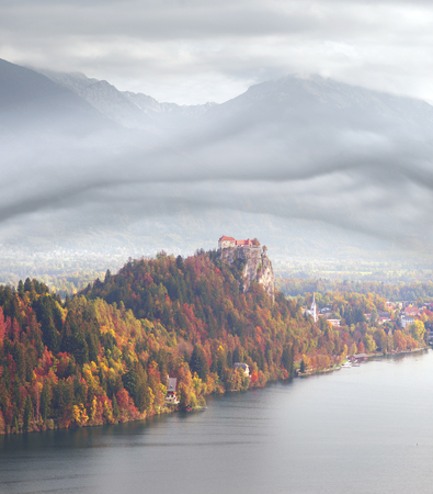 charming small alpine town of Bled with a picturesque island among the lake, a castle on a rocky cliff and the outlines of the Julian Alps in the background - all this creates a stunning landscape.の写真素材