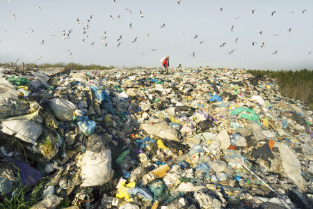 Poor beggar unemployed person collects plastic and bottles and other garbage for surrender for moneyのeditorial素材