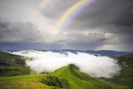 morning fog in the Ukrainian Carpathians after a strong thunderstorm with lightning and thunder over the tops of the ridges, under the mountain Svidovets, Ukraineの写真素材
