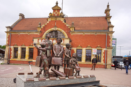 Poland, Gdansk, May 23, 2019: the ancient Polish and German cultural center with beautiful architecture. Famous bronze sculpture of refugees near the stationのeditorial素材