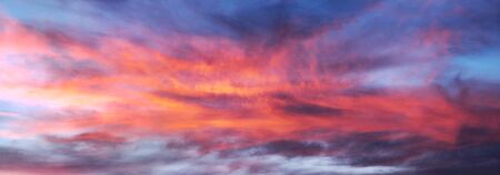 sky glows with the fiery colors of a fabulous sunset - the weather and climate change rapidly with...