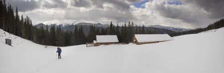 The journey of a lone tourist in the snowy Carpathians among wild forests and fields, where in the spring shepherds will come to graze sheep, and now itâs cold and empty.の写真素材