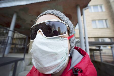 Person wearing sunglasses and a maskの写真素材