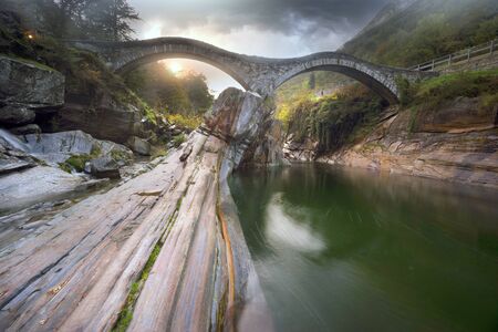attraction of the Verzaska River is the 17th century double-arched Roman bridge - from one of its bends you can make sure that the water is crystalline to the bottom.の写真素材