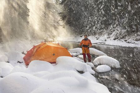 Tourist tent in a snowy canyon. Extreme mountain equipment gives comfort and safety in a tourist...