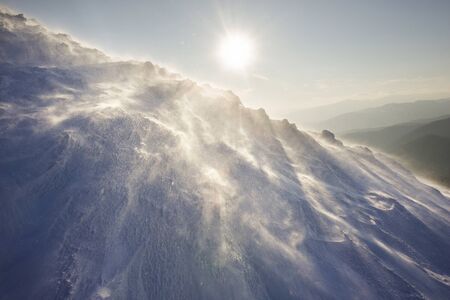 Snowy frosty peak in the Carpathians with beautiful scenery at sunset mountain range in extreme...