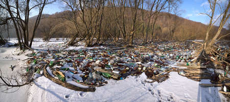 Ukraine, Kolochava, January 20, 2020: Mountain alpine lake in Europe, destroyed by dirty human life. City waste from plastic will spoil the Earth for hundreds of years without decayingのeditorial素材