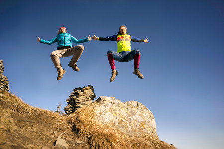 Man and woman jumping to the top.の写真素材