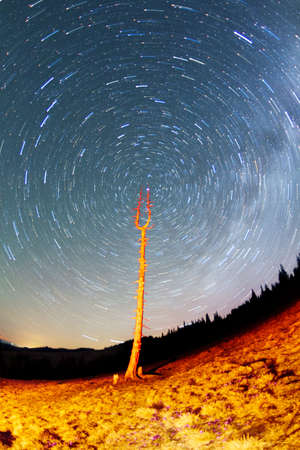 Travelers walk at night. Starry sky above the earth scenic natural phenomena in the atmosphere, a...