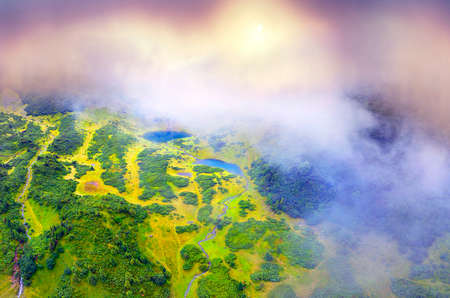 In the mountains of the Carpathians, Ukraine, in a foggy valley of fog, shot by a drone copter, the...