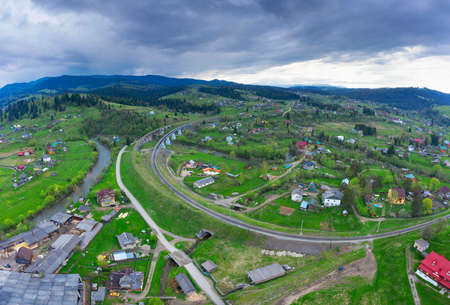 Aerial photo by drone, the wooden church of the Nativity of the Virgin rises on the hill of the village. This is one of the oldest (1654-1657) Hutsul churches, the oldest building in Vorokhta.の写真素材