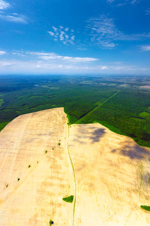 panorama symbol, aerial photo by drone of farming fields in spring. The plowed land is profitable for business, but there is a danger of exhaustion and erosionの写真素材
