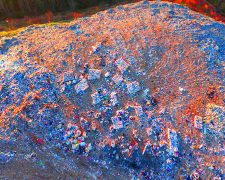 Aerial footage with a drone quadcopter shows bulldozers of European urban waste in a wild forest....