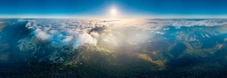 Autumn dawn on Mount Syvuli, Ukraine, a sea of ââfog closes the horizon. A new cloud front has come to the Carpathians - the weather will change. Aerial view drone copterの写真素材