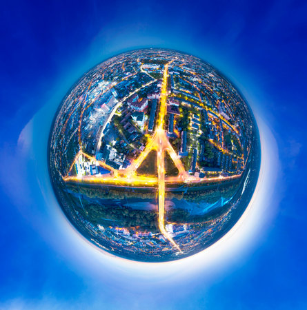 Spherical ball asteroid night panorama of the European city of Ivano-Frankivsk in Ukraine in the evening, lights and windows of houses, cars are shining. Aerial photography by a drone by a quadcopterの写真素材