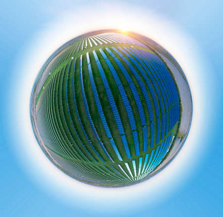 Spherical ball asteroid panorama of a field of solar panels providing clean green electricity to...