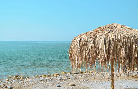 Parasol on the azure coastの写真素材