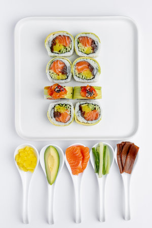 Sushi rolls with salmon, avocado and cucumber on white backgroundの写真素材