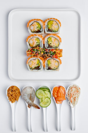 Sushi set on white background. Sushi roll with salmon, shrimp, avocado, cucumber and cream cheese.の写真素材