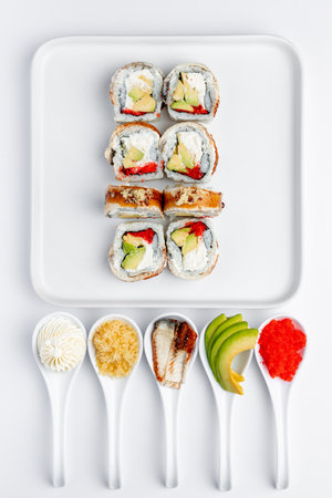 Sushi set on white background. Sushi rolls with salmon, eel, avocado, cucumber and cream cheese.の写真素材