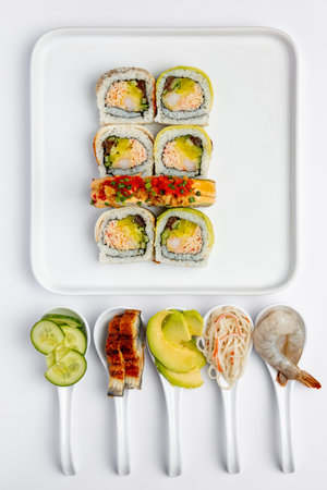 Sushi set on a white background. Sushi rolls with salmon, avocado, cucumber and shrimpの写真素材