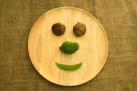 shitake mushroom,broccoli and green pea on wooden dishwareの写真素材