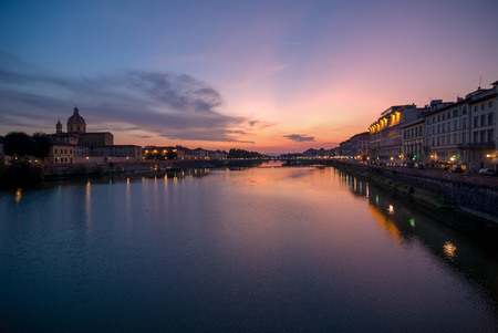 sunset with nice sky and reflection at river arno in florenceの写真素材