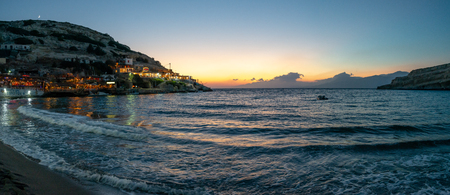 night life at the bay of Matala in evening light right after sunsetの写真素材