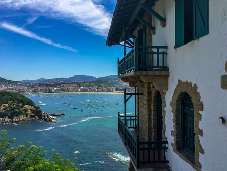 view to the beach of San Sebastian over the bay with lots of boatsの写真素材