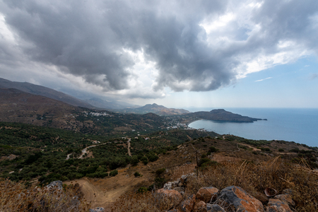 bay of Plakias underneath a sky with heavy rain cloudsの写真素材