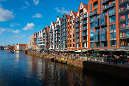 2022-06-10: Beautiful architecture of buildings on embankment in Gdansk. Modern houses over Motlawa...