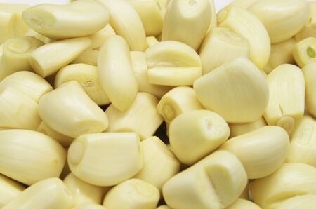 background of trimmed peeled garlic clovesの写真素材