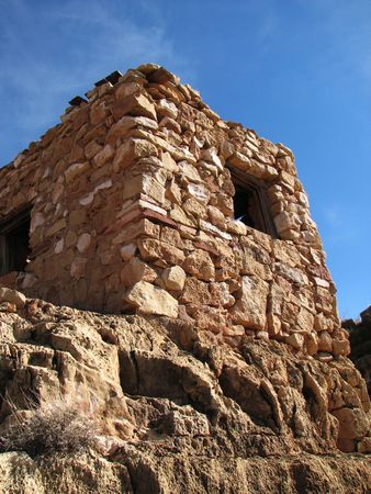 stone ruin in Arizona stands against a blue skyの写真素材