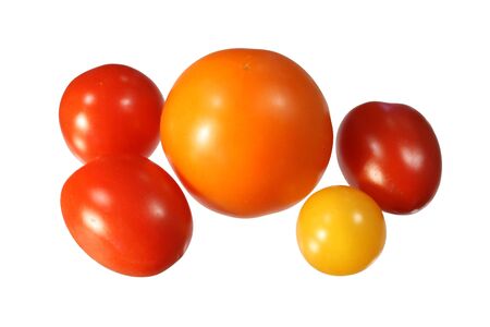 five small red, orange, and yellow tomatoes isolated on whiteの写真素材