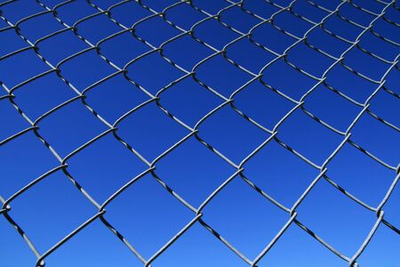 chain link fence mesh with blue sky background